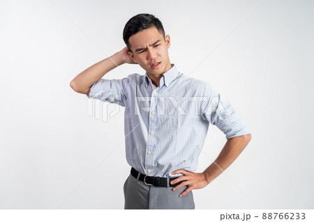 Stressed asian young young man holding head 88766233