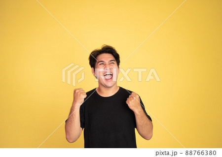 excited asian man with two hands clenched 88766380