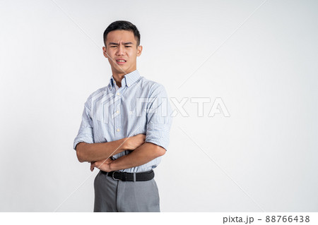asian young man with disgusting expression isolated over white background 88766438