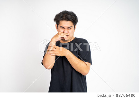 man cover his nose and feeling disgusted by the smell 88766480