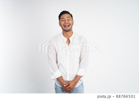 happy asian young man laughing naturally on studio background happy asian young man laughing naturally on studio background 88766501