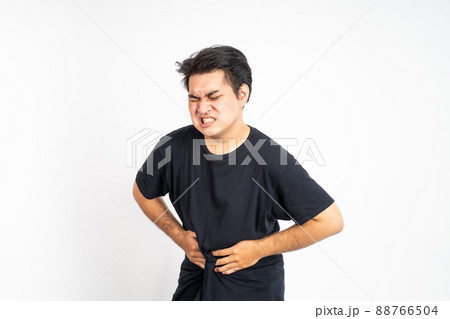 man having stomachache holding his stomach with two hands 88766504