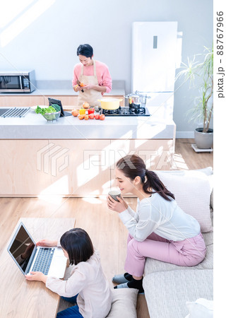 タブレットでレシピを見ながら料理をするパパとリモート授業の子供、見守るママ タブレットでレシピを見ながら料理をするパパとリモート授業の子供、見守るママ 88767966