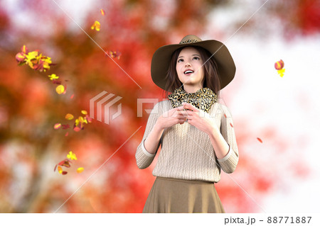 秋の紅葉した風景を背に胸の前で指を組み空を見上げる若い女性 88771887