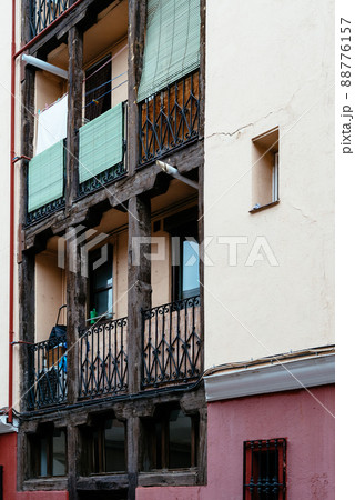 Low angle view of old cast iron balconies of old residential building in Lavapies quarter in Madrid Low angle view of old cast iron balconies of old residential building in Lavapies quarter in Madrid 88776157