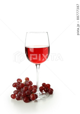 Glass of red wine and grape isolated on white background Glass of red wine and grape isolated on white background 88777387