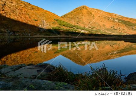 Reflection of Mount Turku in the reservoir of Lake Nesamovyto, Lake Nesamovyte and Mount Turkul, autumn landscapes of the Carpathians. 88782295