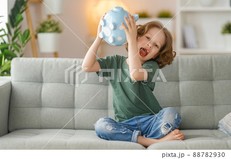 Happy girl with piggy bank. 88782930