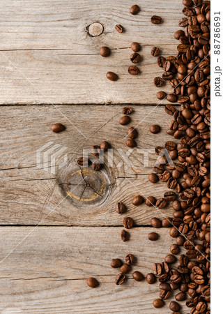 Overhead shot of roasted coffee beans on wooden background. Overhead shot of roasted coffee beans on wooden background. 88786691