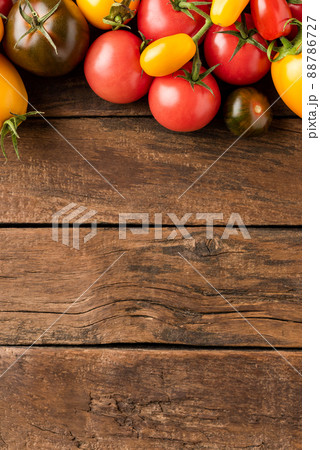 Overhead shot of mixed tomatoes on rustic wooden background with copyspace. Top view Overhead shot of mixed tomatoes on rustic wooden background with copyspace. Top view 88786727