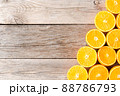 Orange halves on wooden background with copyspace 88786793