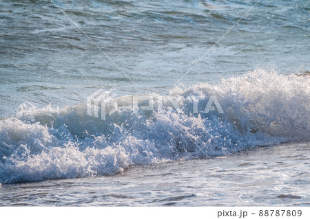 Splashes of water and foam against the sea on a sunny summer day Splashes of water and foam against the sea on a sunny summer day 88787809