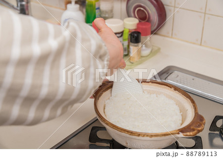 【ミドル主婦が土鍋で炊き立てのご飯をかき混ぜる】 88789113