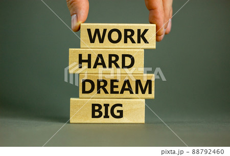 Work hard dream big symbol. Concept words 'Work hard dream big' on wooden blocks on a beautiful grey background. Businessman hand. Business, motivational and work hard dream big concept. 88792460