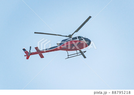 Small transport helicopter flying in the sky. 88795218