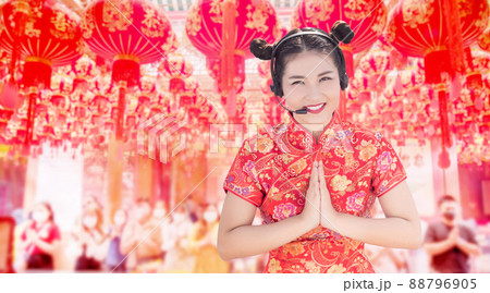 Asian in red Chinese dress Show greetings and headsets for Chinese temple Asian in red Chinese dress Show greetings and headsets for Chinese temple 88796905