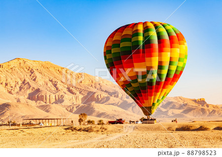 View of colorful hot air balloons with passengers landing on the plane at Valley of The Kings. 88798523