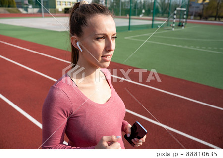 Fitness training music. Girl choose music for running. Lifestyle workout exercise woman training. Fitness, sport, lifestyle concept. 88810635