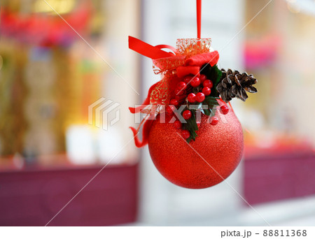 Red Christmas ball, hanging on the market of Bellinzona, Switzerland Red Christmas ball, hanging on the market of Bellinzona, Switzerland 88811368