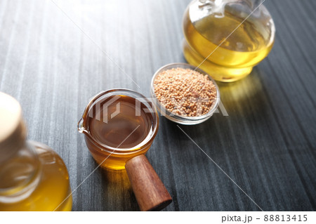 sunflower coking oil and seeds in a container on table  88813415