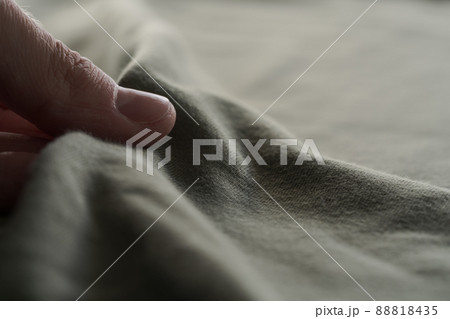 man hand touching green cotton fabric 88818435