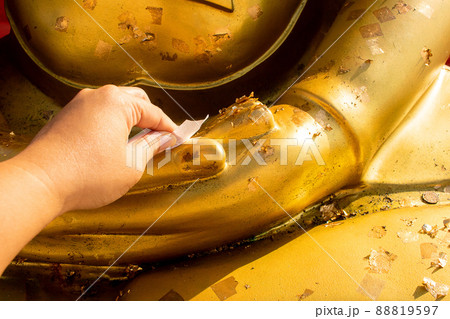 Buddhists covered gold leaf the statue of Buddha. Buddhists covered gold leaf the statue of Buddha. 88819597