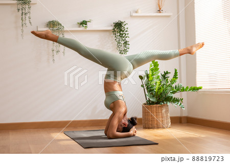 Side view of Asian woman wearing green sportwear doing Yoga exercise,Yoga Child pose or Balasana,Calm of healthy young woman breathing and meditation with yoga at home Side view of Asian woman wearing green sportwear doing Yoga exercise,Yoga Child pose or Balasana,Calm of healthy young woman breathing and meditation with yoga at home 88819723