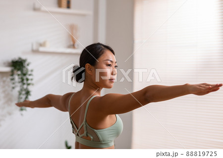 Side view of Asian woman wearing green sportwear doing Yoga exercise,Yoga Child pose or Balasana,Calm of healthy young woman breathing and meditation with yoga at home Side view of Asian woman wearing green sportwear doing Yoga exercise,Yoga Child pose or Balasana,Calm of healthy young woman breathing and meditation with yoga at home 88819725