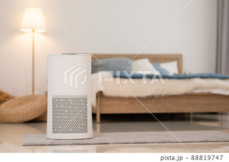 Air purifier in cozy white bedroom for filter and cleaning removing dust PM2.5 HEPA and virus in home,for fresh air and healthy Wellness life.Health care Air Pollution Concept 88819747