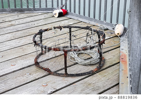 View of a crab trap on a deck with buoys View of a crab trap on a deck with buoys 88819836