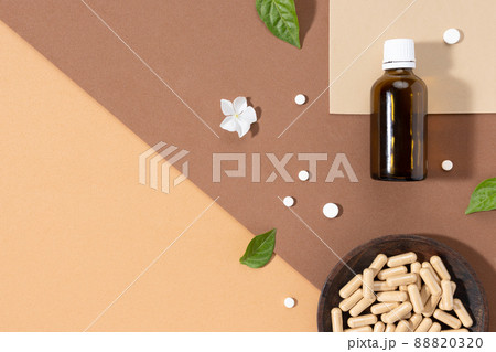 Flat lay composition of various vitamin capsules and dietary supplements on brown background with copy space. Vitamin complexes concept. Flat lay composition of various vitamin capsules and dietary supplements on brown background with copy space. Vitamin complexes concept. 88820320