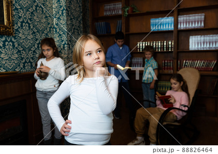 Thoughtful preteen girl solving puzzle in escape room 88826464