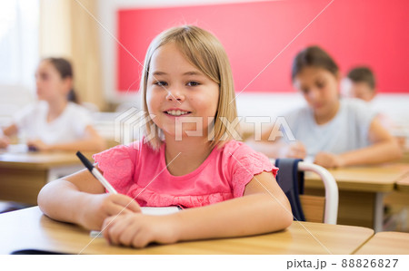 Schoolgirl sitting in classroom Schoolgirl sitting in classroom 88826827