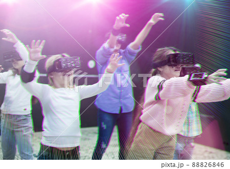 Happy tweens in VR glasses playing virtual reality games, toned image 88826846