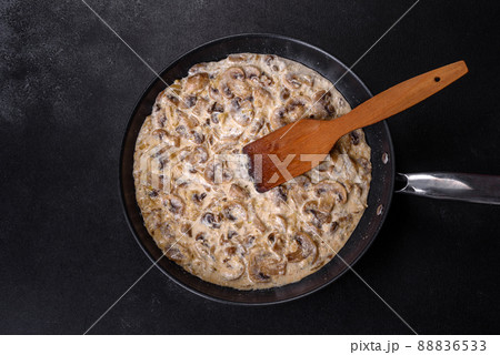 Delicious fresh young champignons sliced into slices in creamy sauce Delicious fresh young champignons sliced into slices in creamy sauce 88836533