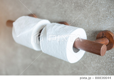 Woman hand pulling toilet paper in restroom. Cleaning, Lifestyle and personal hygiene concept 88836644