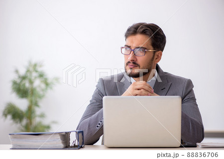 Young male employee working in the office Young male employee working in the office 88836706