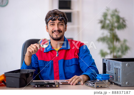 Young male repairman repairing computer 88837187