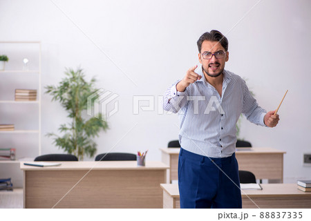 Young male teacher in the classroom Young male teacher in the classroom 88837335