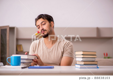 Young male student studying at home during pandemic 88838103