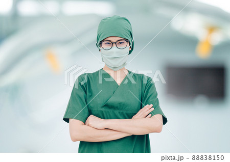 Portrait of Asian nurse standing and crossed-arms in hospital operation room. Ready for work in surgery operating in modern operation room. Portrait of Asian nurse standing and crossed-arms in hospital operation room. Ready for work in surgery operating in modern operation room. 88838150