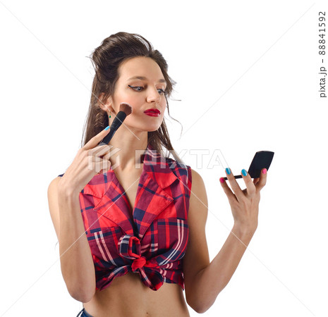 Beautiful woman with mirror and makeup brush Beautiful woman with mirror and makeup brush 88841592