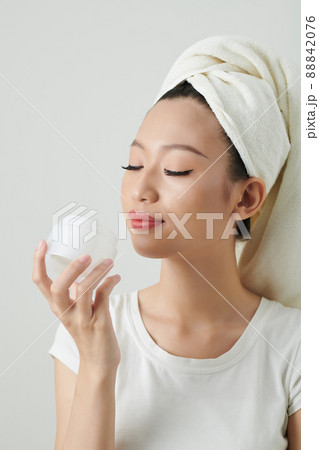 Woman Enjoying Smell of Lotion 88842076