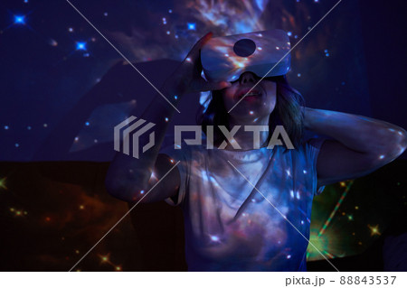 Woman is using virtual reality headset. Elements of this image furnished by NASA. Woman is using virtual reality headset. Elements of this image furnished by NASA. 88843537