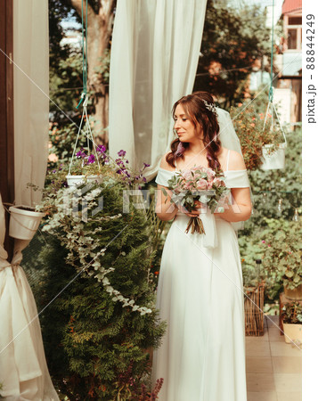 Wedding hairstyle and makeup, beautiful young bride with flowers wreath at marriage morning, happy caucasian girl bridal look. grain effect Wedding hairstyle and makeup, beautiful young bride with flowers wreath at marriage morning, happy caucasian girl bridal look. grain effect 88844249