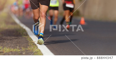 Marathon running race, people running on city road Marathon running race, people running on city road 88844347