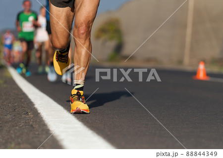 Marathon running race, people running on city road Marathon running race, people running on city road 88844349