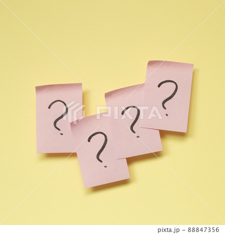 Question mark on pink memo paper on yellow background Question mark on pink memo paper on yellow background 88847356