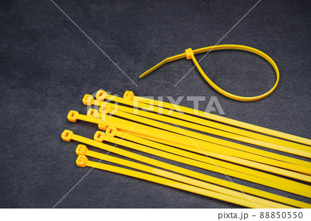 Yellow cable tie on the cement floor background Yellow cable tie on the cement floor background 88850550
