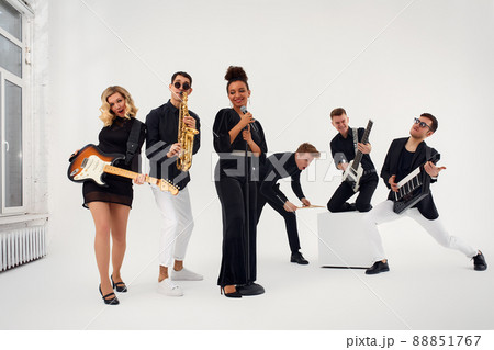 Portrait of diverse group of young people musical band playing with instruments - isolated on white background. Portrait of diverse group of young people musical band playing with instruments - isolated on white background. 88851767